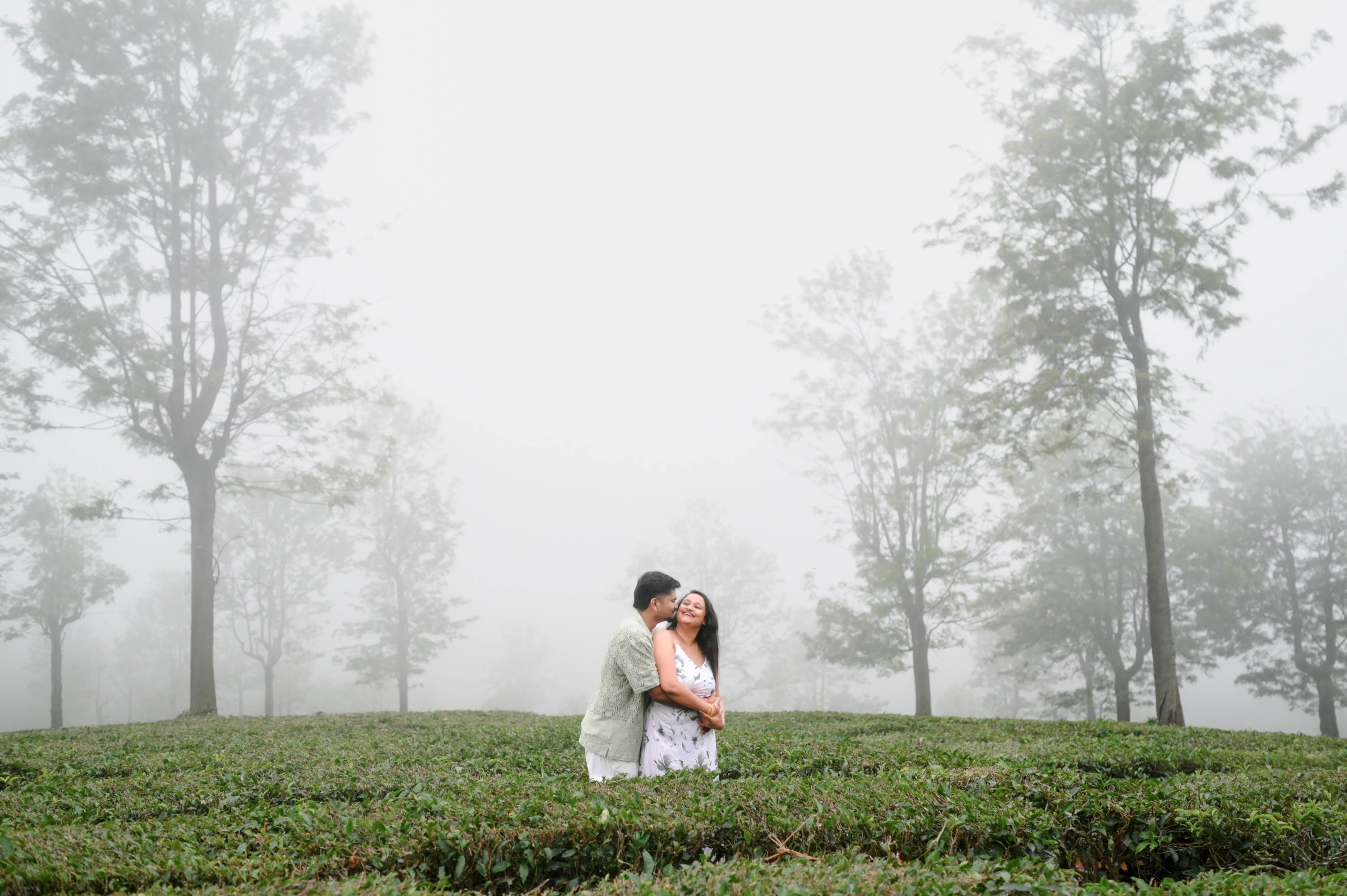 Sruthi and Sridharan sharing a laugh during their misty Ooty save the date photoshoot.