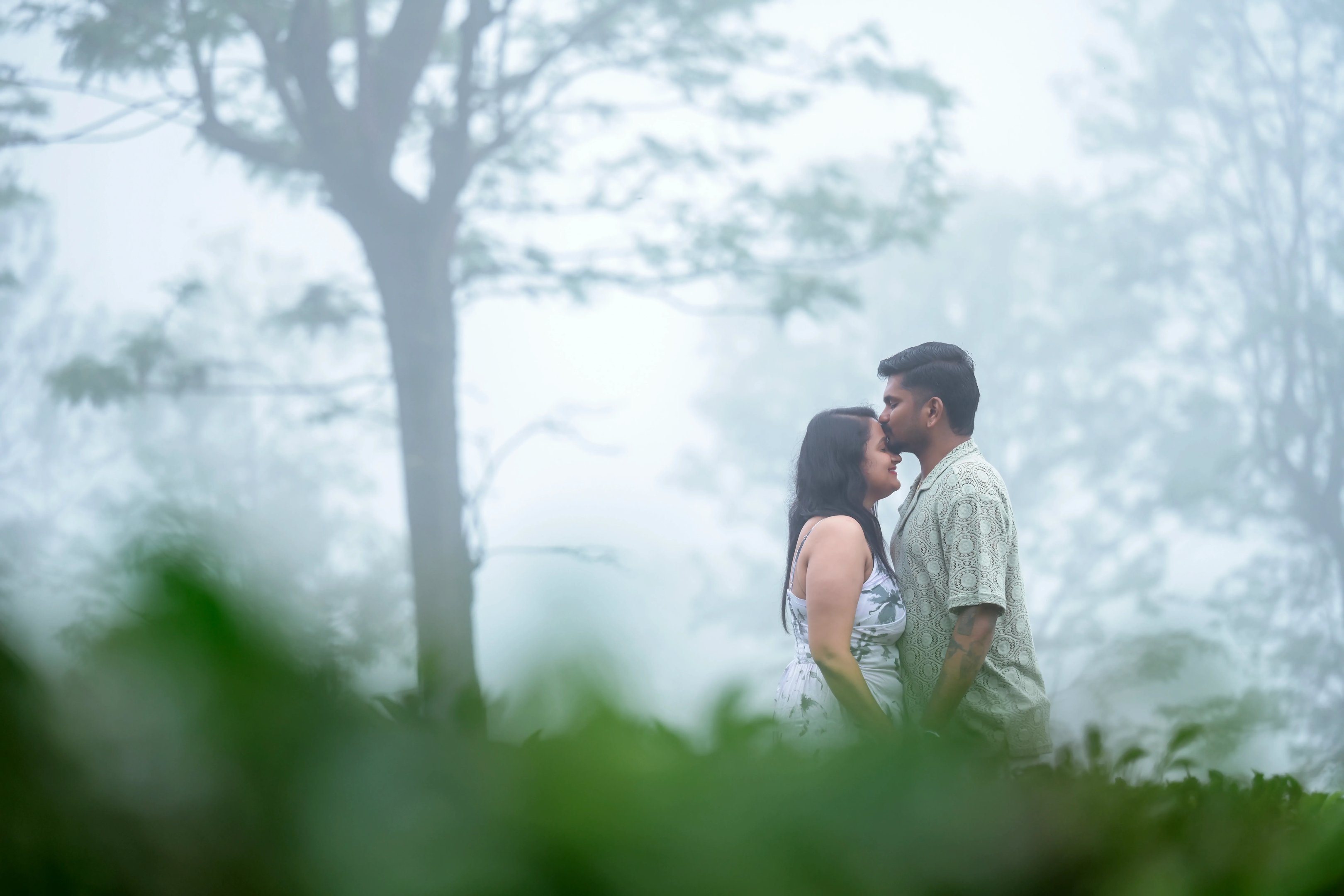 The couple sharing a tender moment under an umbrella during their Ooty photoshoot.