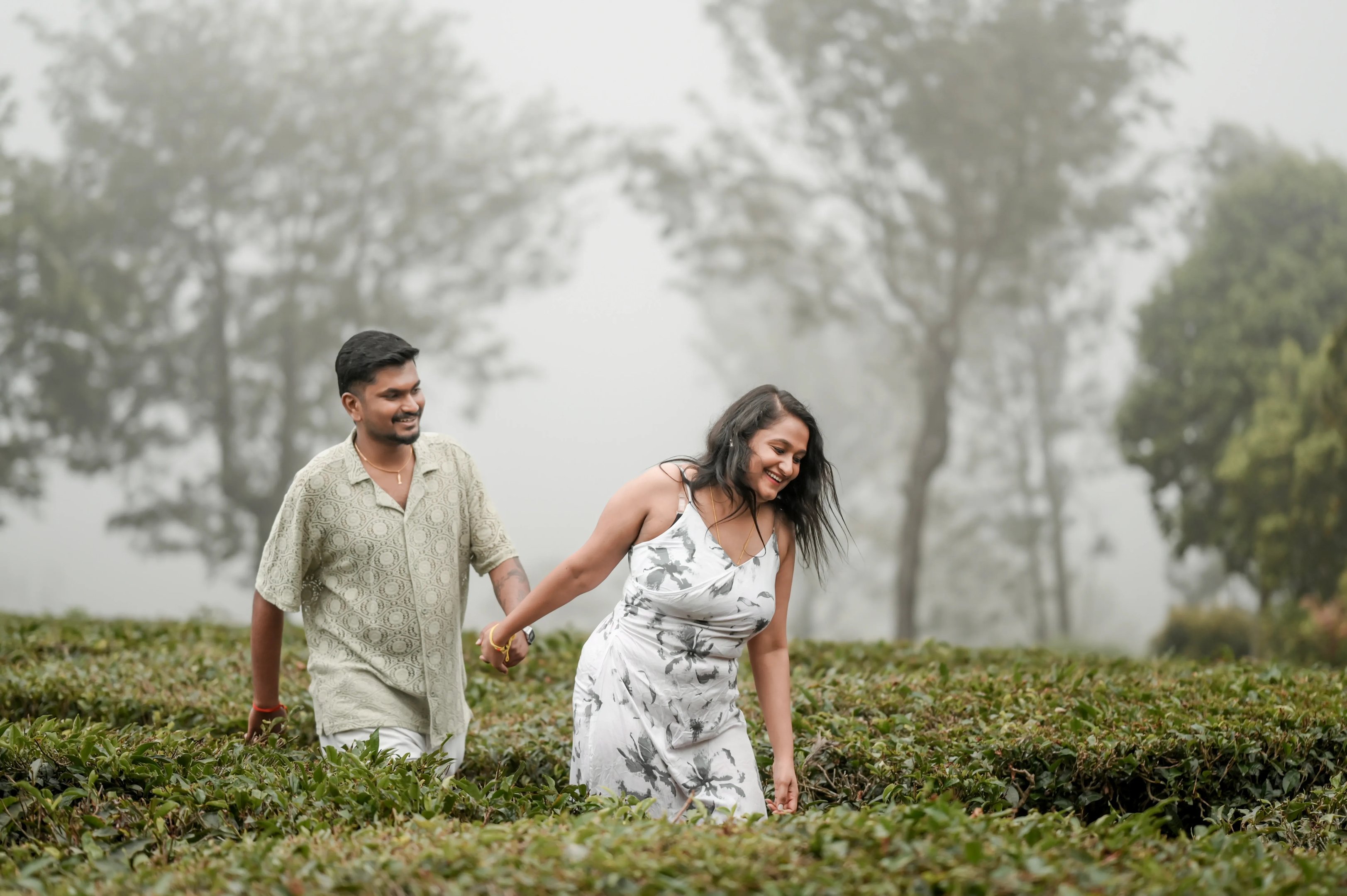 The couple walking away into the mist, a cinematic end to their Ooty photoshoot.