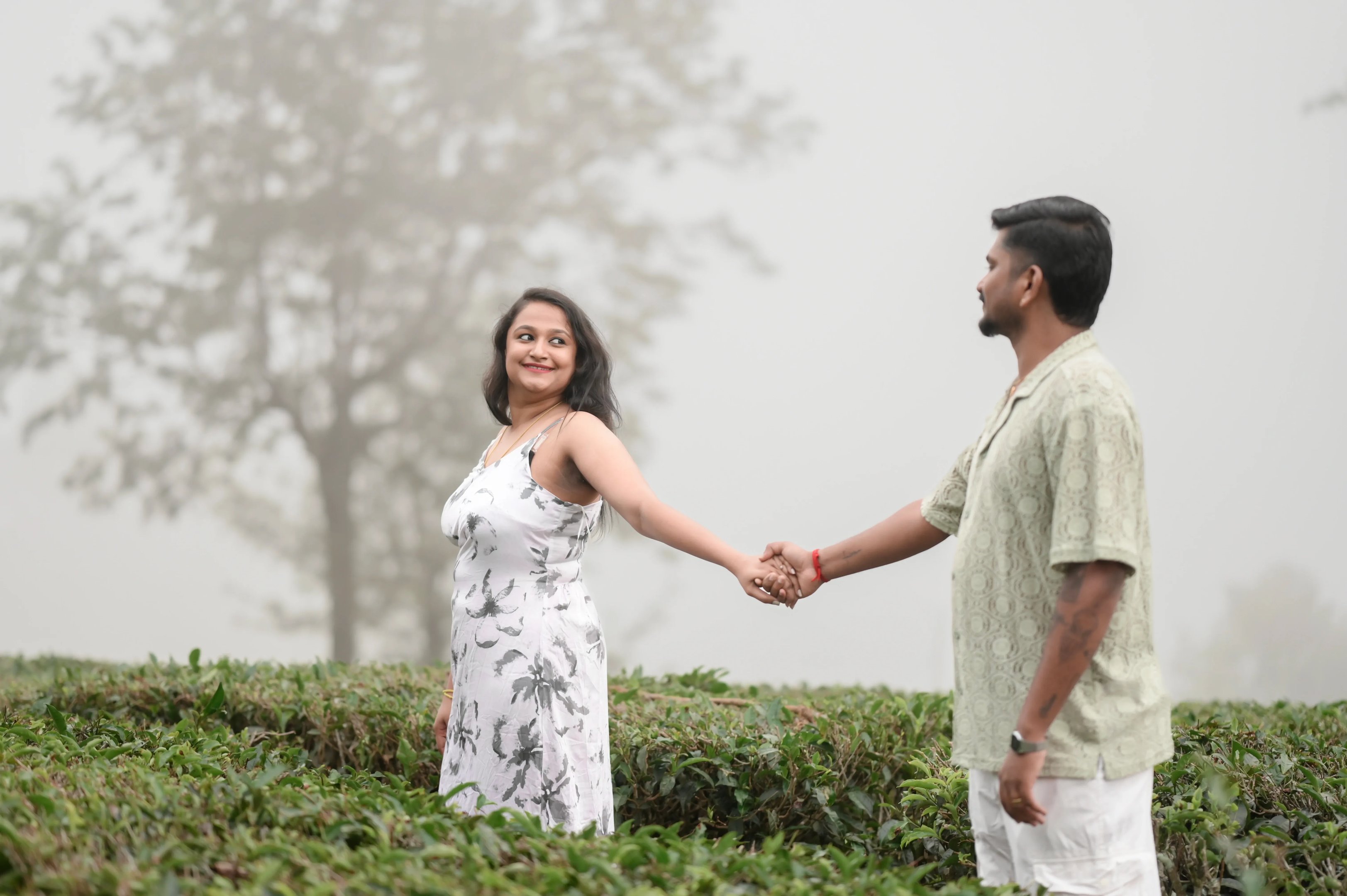 The couple looks out at the misty mountains of Ooty.
